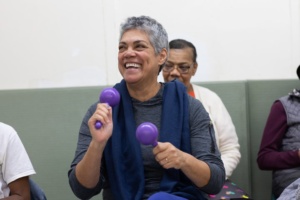 Older adult participant plays with Maracas..