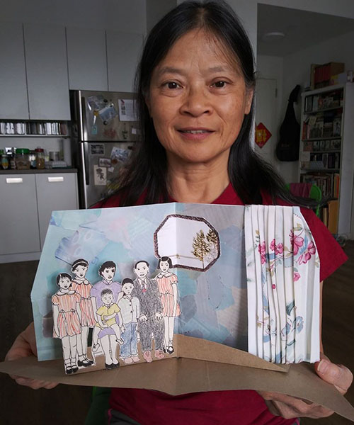 LaGuardia Senior Center student, Margaret Yuen, sharing her pop-up memory book, “A Prosperous Family全家福.