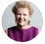 This is a headshot of Maura O'Malley, Lifetime Arts' CEO/Co-Founder. She has short curly hair and is smiling.